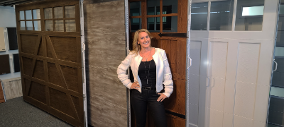 Woman standing in front of doors smiling