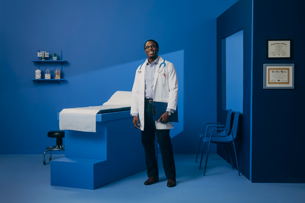 Doctor smiling in patient room.