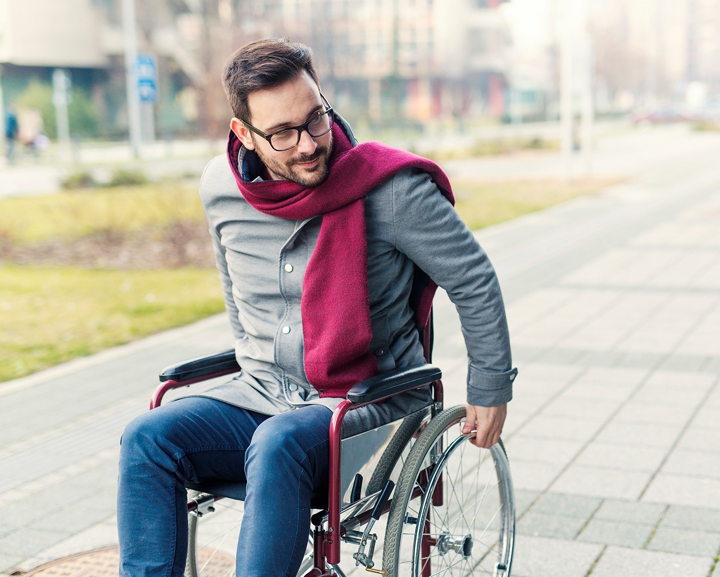 Man in wheelchair on sidewalk
